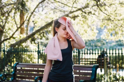 A woman wiping during workout.