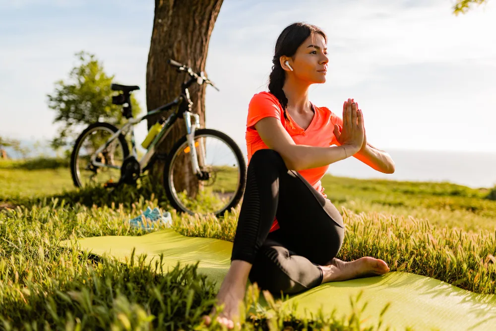 A woman practicing outdoor mindful yoga